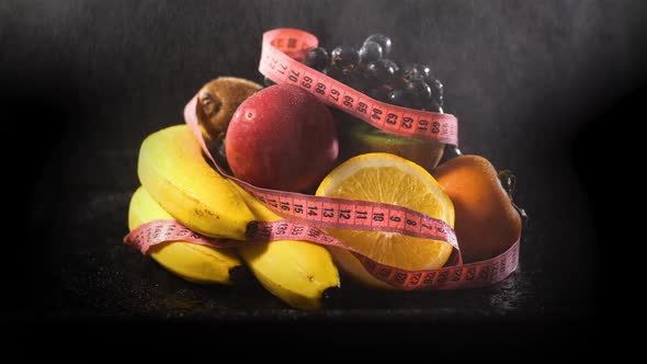 Spraying Fresh Fruits Covered with Measuring Tape