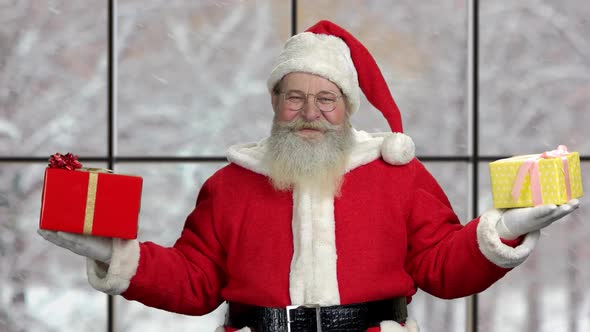 Cheerful Santa Claus Holding Christmas Gifts