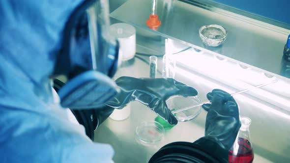 Specialist is Analyzing a Liquid Sample in the Laboratory Cabinet