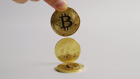 Physical Bitcoin Dropped Down on White Background