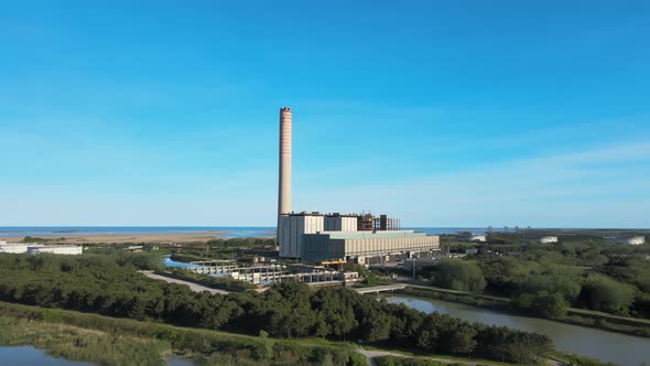 Aerial view of old thermoelectric plant with big chimne in a rural landscape