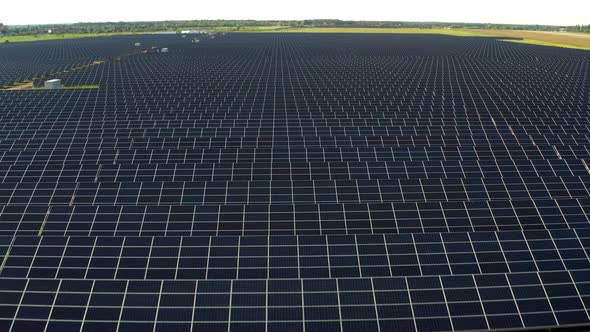 Top view of the power plant with solar panels. Beautiful green fields.