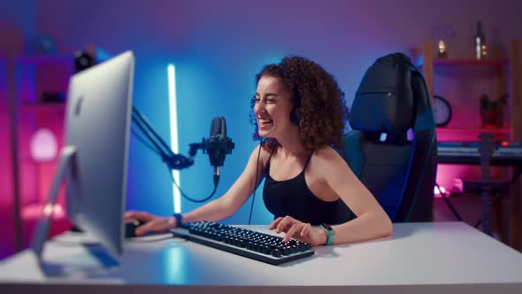 Young Woman Wearing Headphones Playing Computer Game Neon Fashion Room Winner