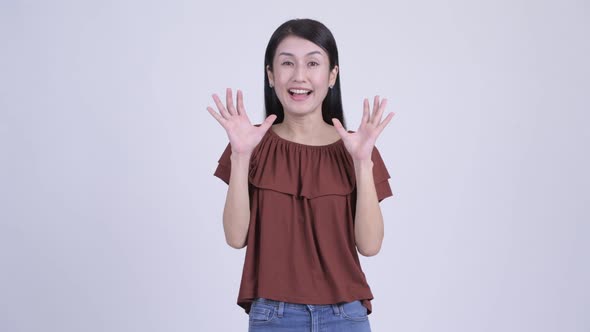 Happy Beautiful Asian Woman Looking Surprised