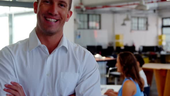 Portrait of smiling business executive with arms crossed