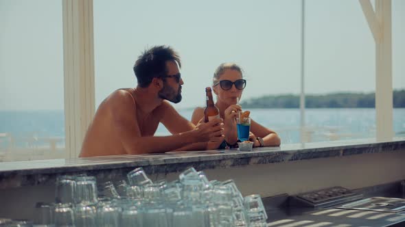 Romantic Couple Drinking Beer On Bar Counter. Honeymoon Lovers Vacation Travel In Greek Resort.