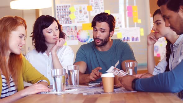 Business colleagues discussing over a document