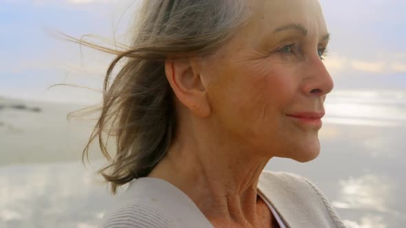 Active senior Caucasian woman standing on the beach 4k