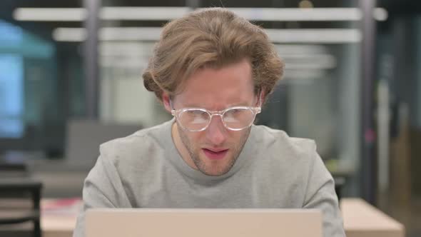 Portrait of Businessman with Laptop Having Loss Failure