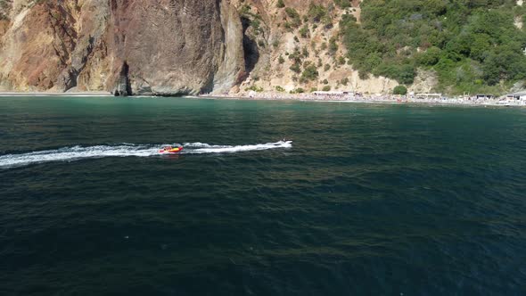 Happy People Swim on Air Mattress Behind a High Speed Water Bike