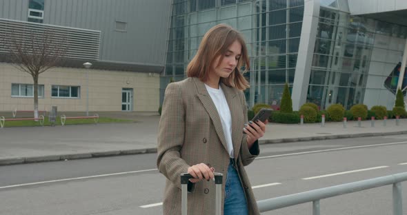 A Young Girl Is Texting a Message and Smiling, Travel By Plane, Sunny Weather