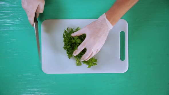 Chef Cook Cutting Parsley on a White Board