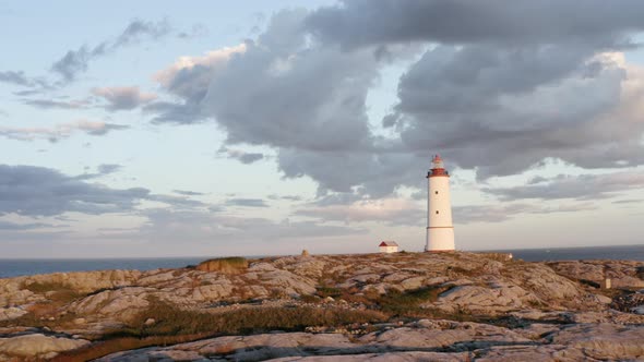 Cloudy Sunset Sky Over Lille Torungen Lighthouse In Arendal, Norway - aerial drone shot