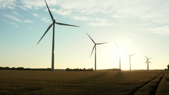 Cinematic Drone View of a Scenic View of a Wind Turbine Farm During Sunset