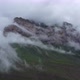 Drone Flight above green fields at the mountains in the clouds and fog. - VideoHive Item for Sale