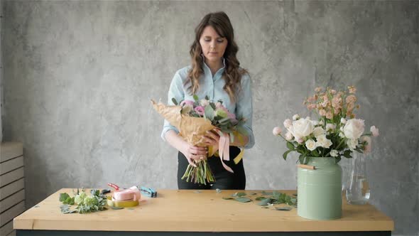 Portrait of Happy Female Florist with Bouquet Roses and Peone Looking at Camera