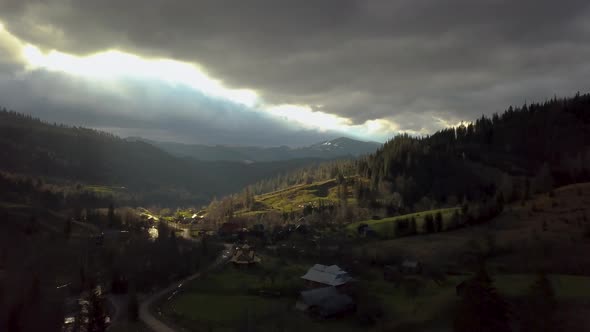Aerial View of Storm Clouds and a Village in the Mountains