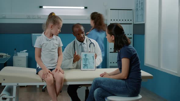 Physician Explaining Human Skeleton Picture on Digital Tablet