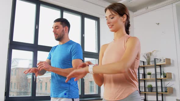 Happy Couple Exercising at Home