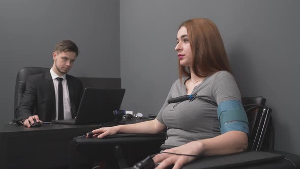 Young Bearded Man Testing Lady with Computer Polygraph