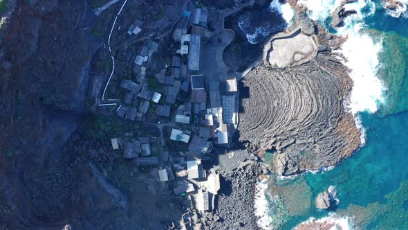 Vertical down aerial descent to fishing village Pozo de Las Calcosas