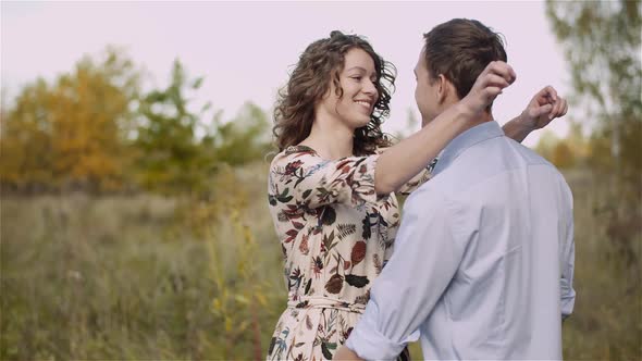 Man Embracing Woman, Hugging and Smiling To Each Other