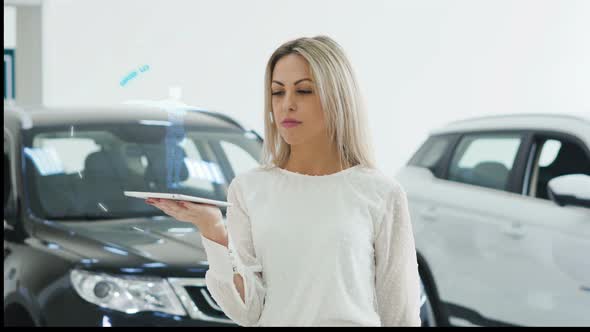 The Girl in the Showroom Holds a Hologram Robot