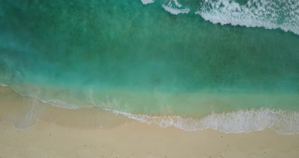 Tropical drone copy space shot of a sandy white paradise beach and aqua blue water background in hi 