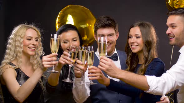 Happy Friends Clinking Champagne Glasses at Party