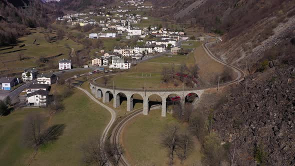 Train on Brusio Spiral Viaduct in Switzerland