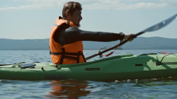 Man Rowing a Kayak