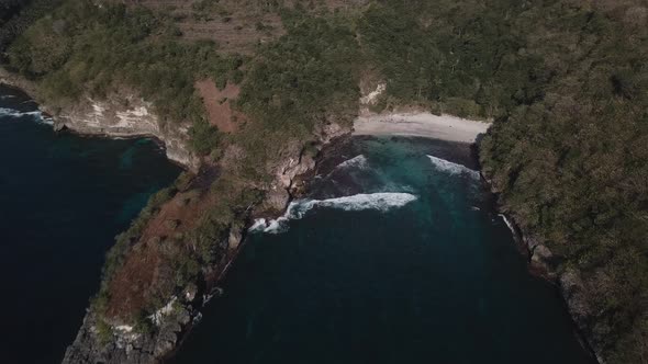 Aerial View of Tropical Beach with Azure Blue Water and Foaming Ocean Waves