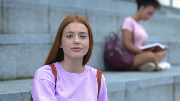 Beautiful Female Student With Backpack Smiling at Camera, Resting Campus Stairs