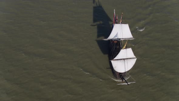 An aerial footage revolving around the Halve Maen ship at the middle of the sea. This is a replica o