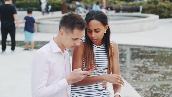 African Young Woman Is Upset Because of Her Boyfriend Looking in the Smartphone All the Time