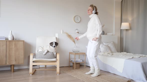 Happy Pregnant Woman Listening Music In Headphones And Dancing In Bedroom