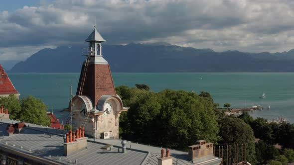 Aerial of old clock tower overlooking beautiful lake Geneva