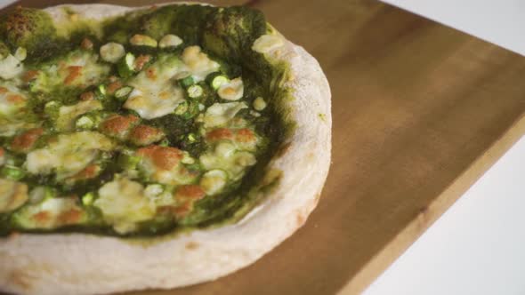 Slow Motion Pan from right to left of a delicious homemade Italian vegetarian pizza with a sourdough