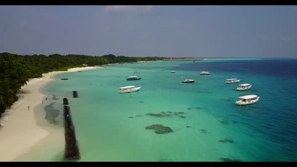 Aerial drone shot tourism of paradise lagoon beach lifestyle by turquoise ocean with white sand back