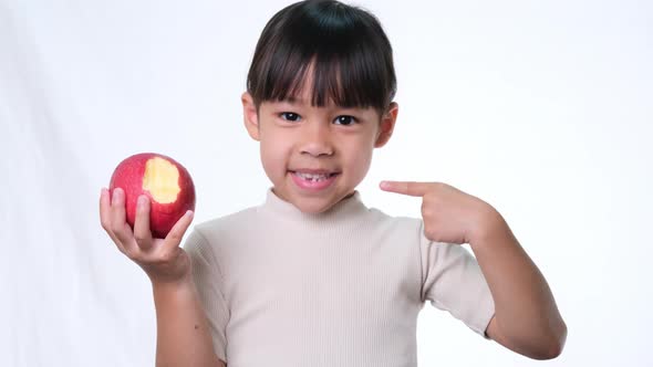 Happy little girl with apple.