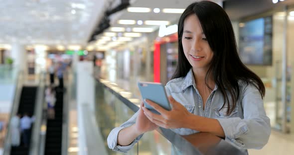 Woman use of mobile phone in shopping mall