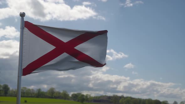 Alabama Flag on a Flagpole Waving in the Wind in the Sky