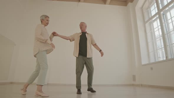 Senior Couple Ballroom Dancing in Dance Studio