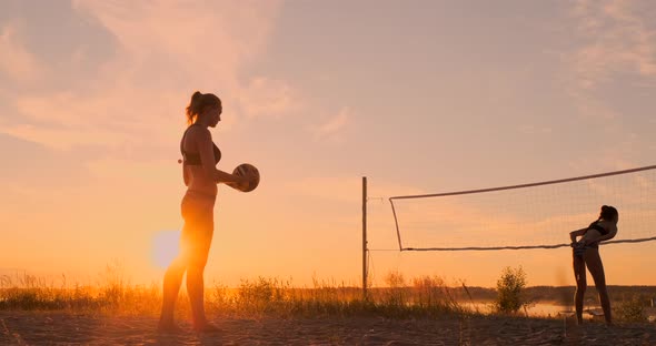 Beach Volleyball Serve - Woman Serving in Beach Volley Ball Game. Overhand Spike Serve. Young People