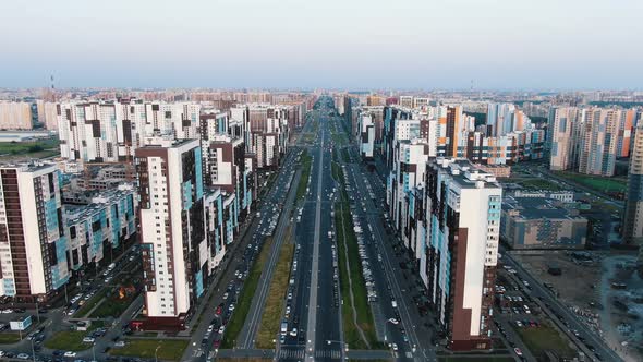 Flying on a Drone Over a Wide City Avenue Between High Multistorey Residential Buildings