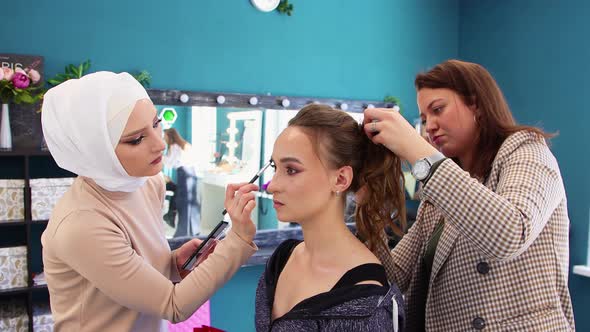 The Girl Has Her Eyebrows Dyed and Her Hair is Styled By Two Masters