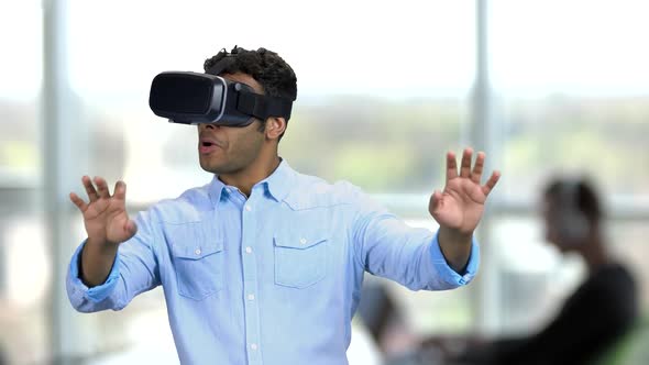 Young Scared Man Wearing Virtual Reality Glasses.