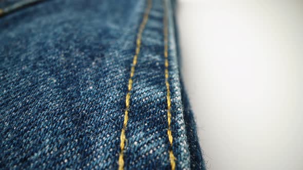 Extreme detailed of blue denim jeans texture in dolly shot over cloth surface.