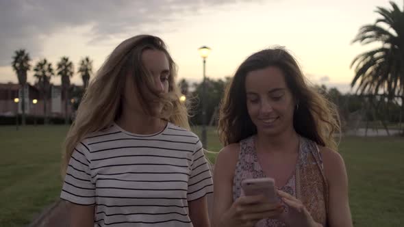 Slow motion shot of young women walking in park