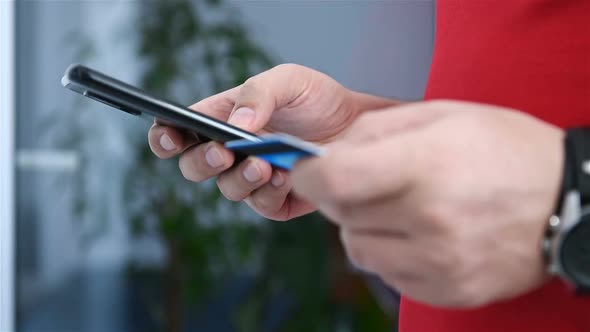 Man Enters Credit Card Details For Purchase